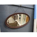 Oval bevelled mirror in oak frame