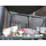 Cage containing coloured wine glasses, jug, cups and saucers, glassware and ornamental flowers