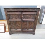 Oak double door cupboard with carved panels