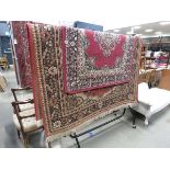 Two floral patterned carpets with red borders