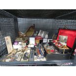 Cage containing badges, wristwatches, military photographs, water bottle and insignia