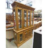 Modern walnut effect glazed bookcase with cupboard base under