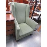 Green fabric wing back armchair