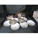 Cage containing floral patterned crockery and modern Chinese teacups