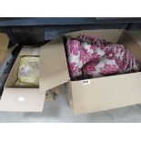 2 boxes containing floral patterned curtains