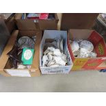 Three boxes containing ornamental boots, floral patterned crockery, and china