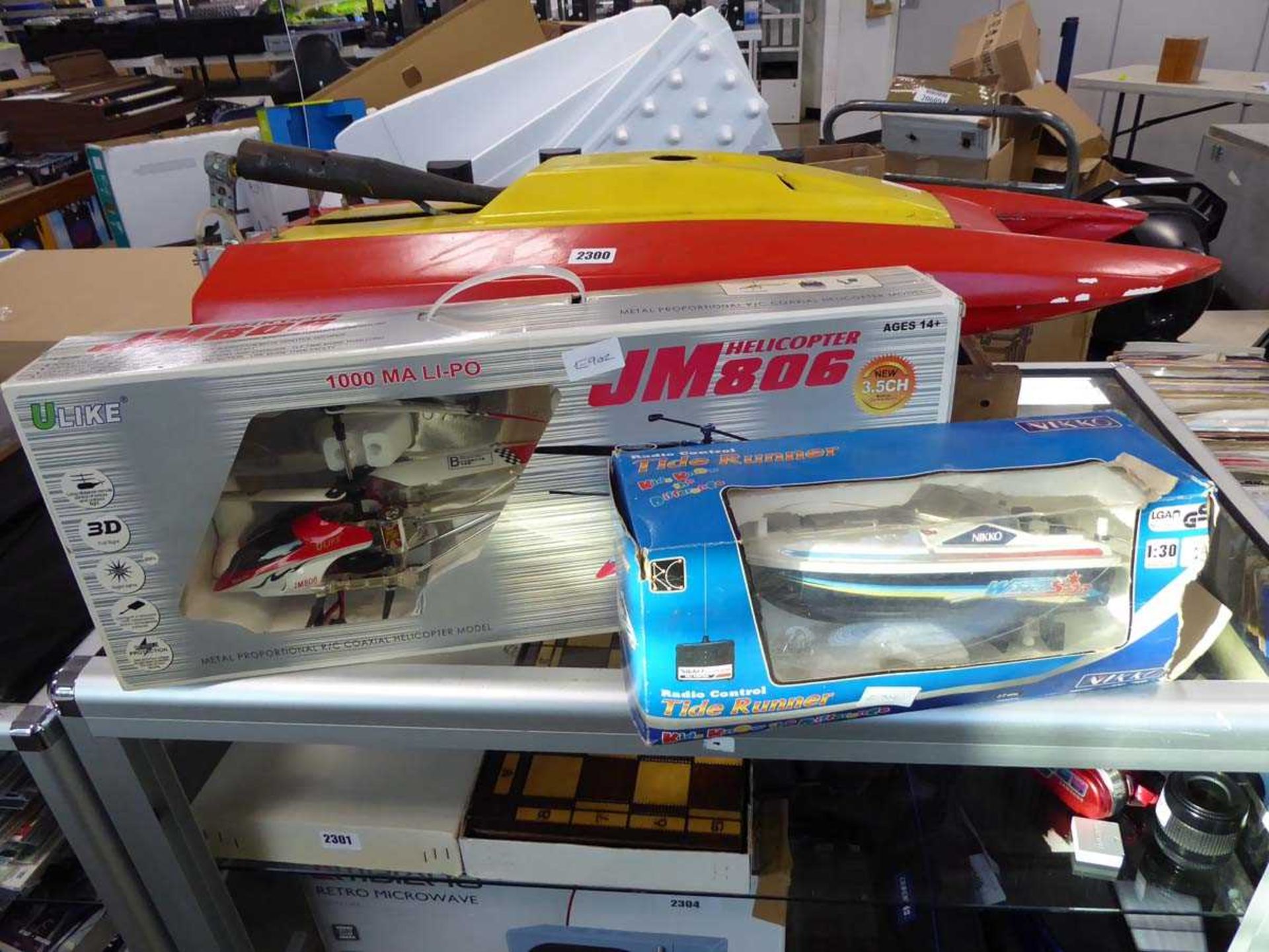 Nikko RC boat, helicopter and large scale petrol powered speed boat and stand