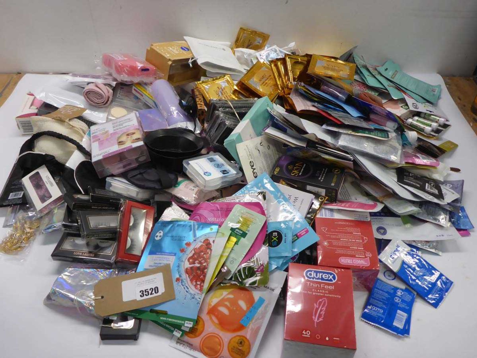 +VAT Large bag containing face & fee masks, hand wipes, Durex, beauty sample sachets, false nails,