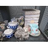 Cage containing collectors plates, blue and white terrines, stainless steel and water jug
