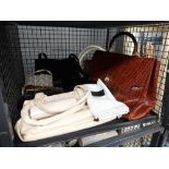 Cage containing vintage leather and fabric bags
