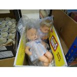 Box containing children's dolls and clothing