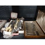 Cage containing loose and boxed cutlery