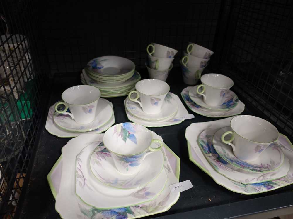 Cage containing shelly flower patterned crockery