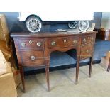 A George III mahogany bow-fronted sideboard with an arrangement of four drawers on square tapering