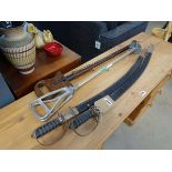 Two cavalry officer's swords plus two shooting sticks