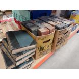 2 boxes containing piano rolls and stack of children's dictionaries