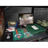 Cage containing Eddie Stobart branded collectors plates and notepads