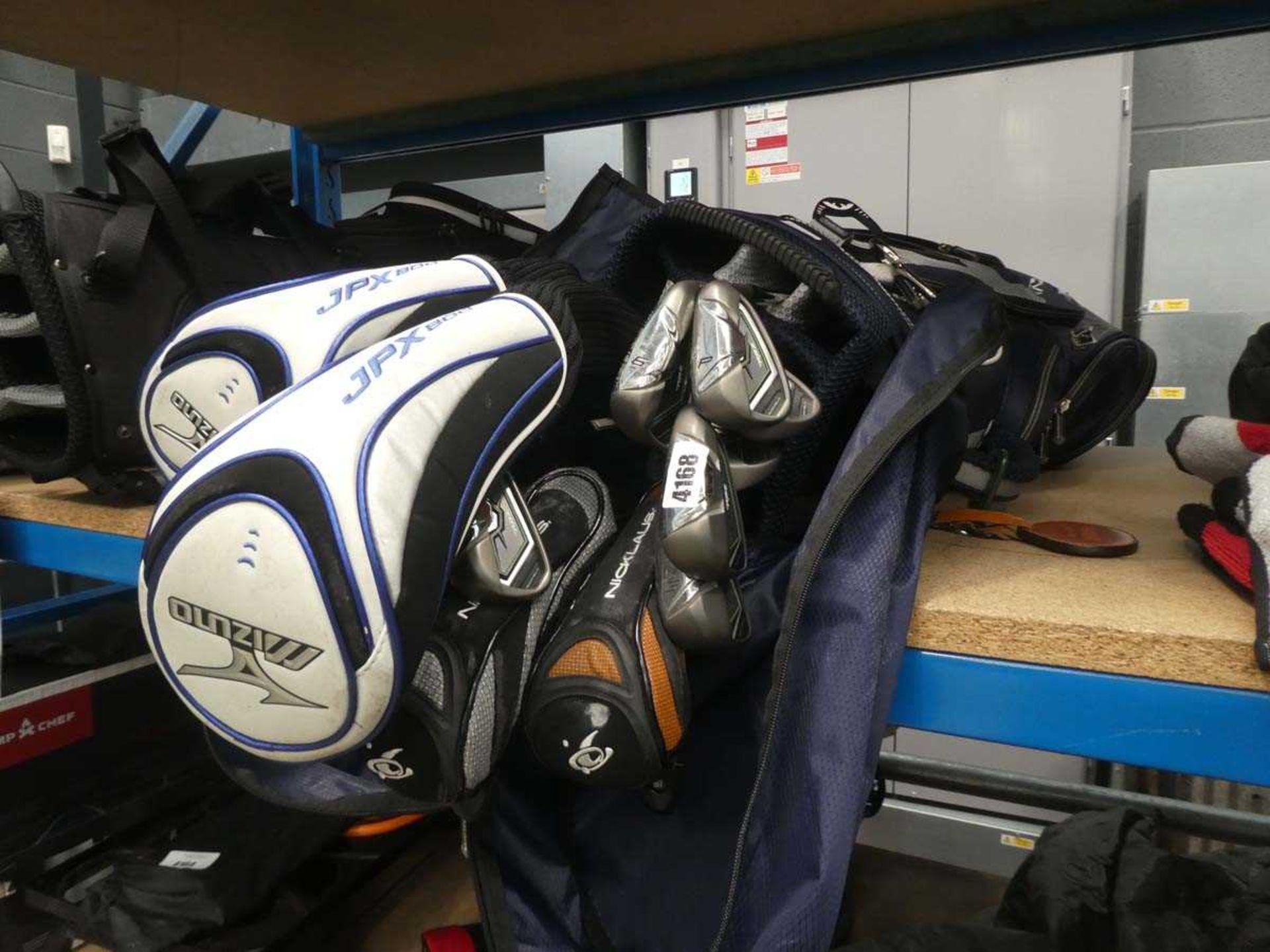 Blue golf bag containing a range of Mizuno, TaylorMade, RBZ and other clubs
