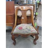 Carved walnut chair with rose embroided seat
