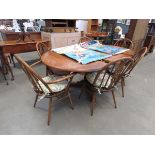 Ercol extending dining table plus six chairs, to include two carvers