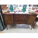 Walnut sideboard with three central drawers and cupboards to the side