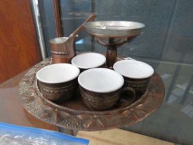 Beaten copper tray with a Chinese tea service