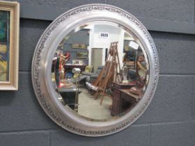 Circular bevelled mirror in silver painted frame