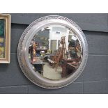 Circular bevelled mirror in silver painted frame