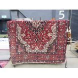 (8) Turkish woollen mat with red border and central medallion