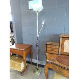 A brass finished mother and child floor lamp