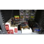 Cage of boxed diecast vehicles including buses, football themed cars, etc