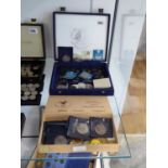 2 cases containing various UK and other coinage