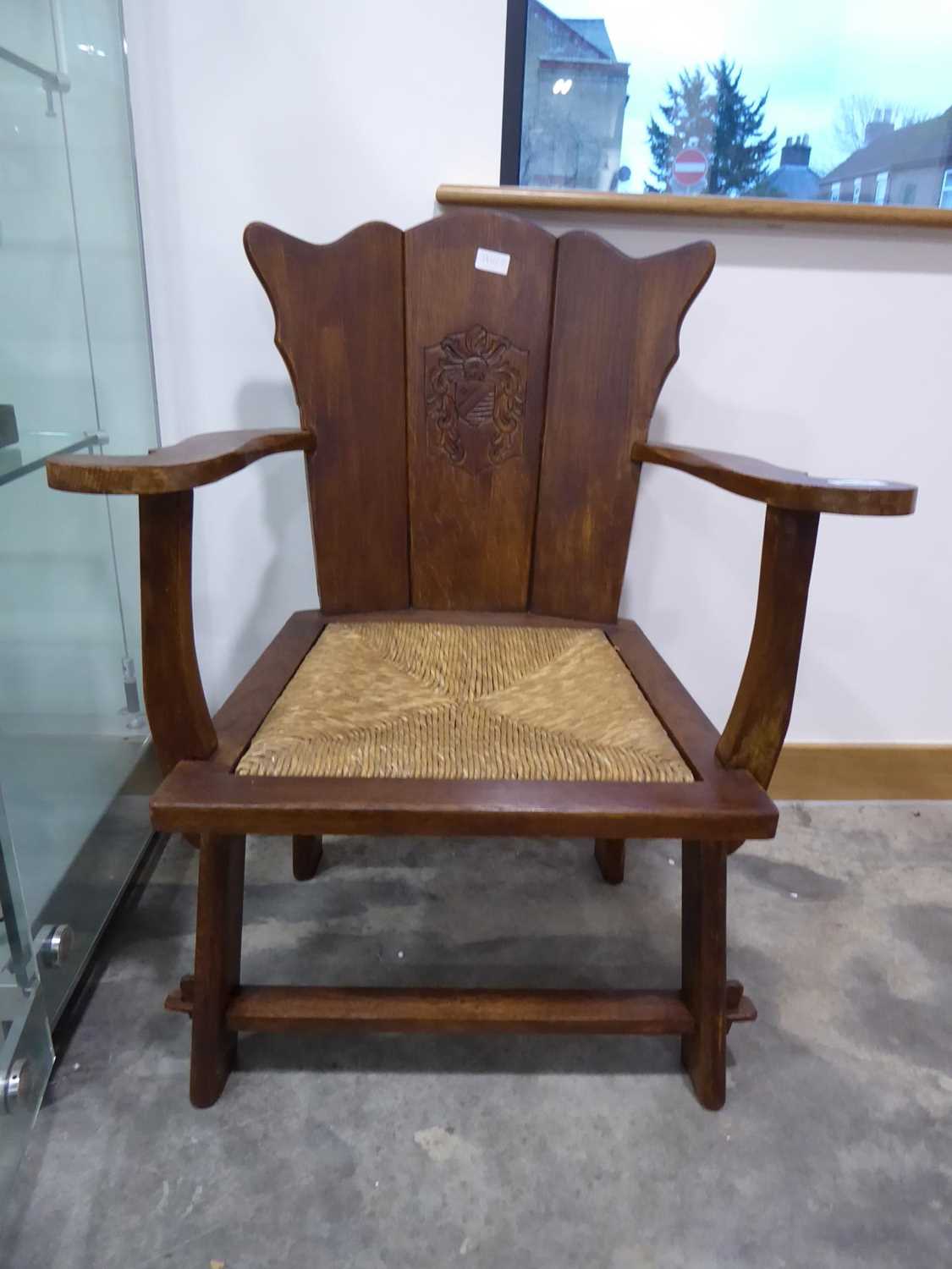 Rush seated oak armchair with emblem to back