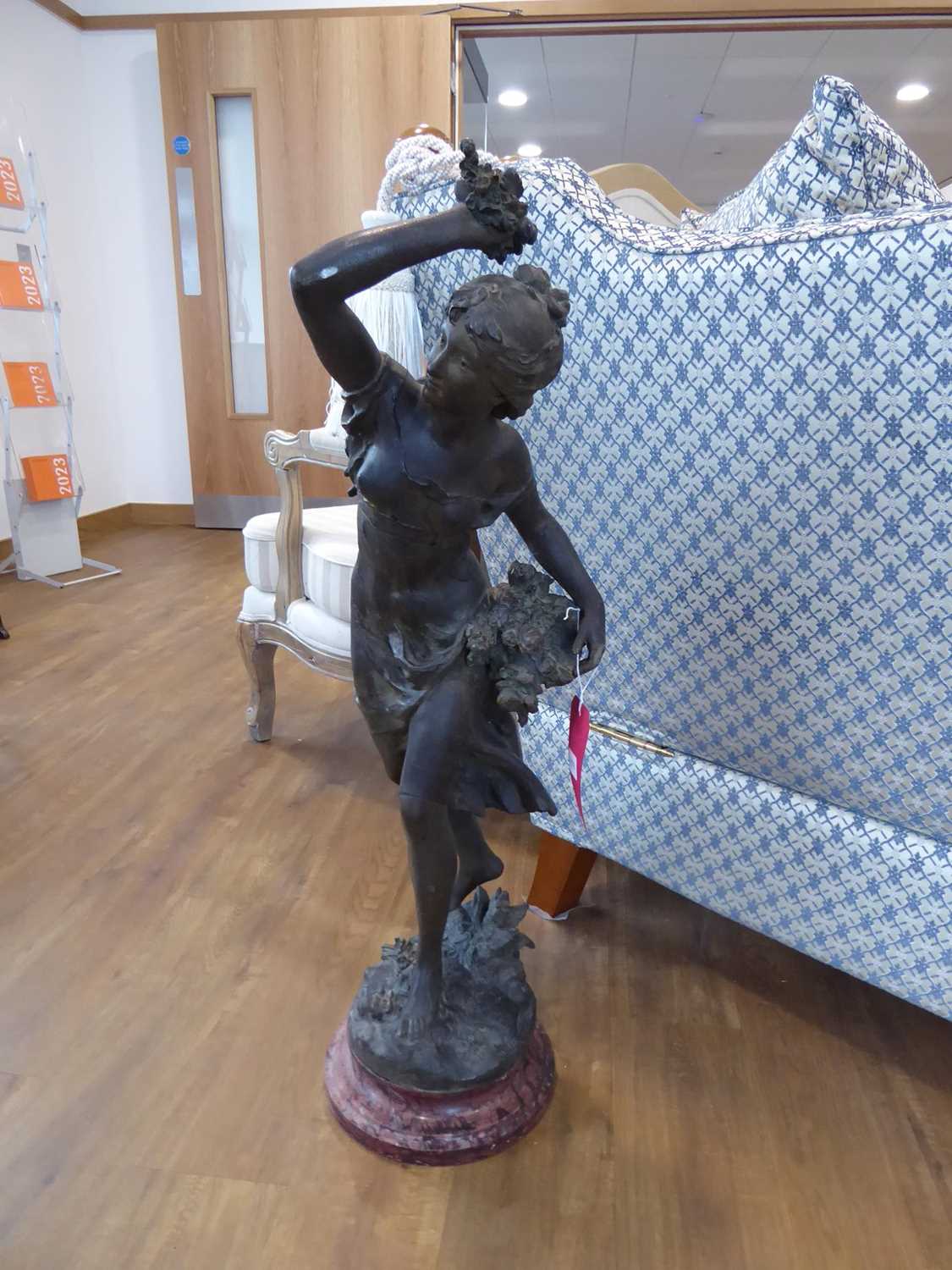 Large patinated Spelter figure of woman bearing flowers after Math Moreau