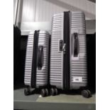 +VAT 2 silver coloured wheeled luggage cases