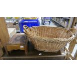 Twin handled wicker laundry basket and small oak stool with leather surface