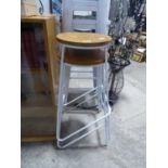 2 wrought metal white stools with circular wooden seats