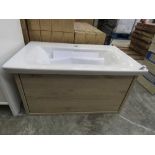 Light wooden wall hung vanity unit with sliding drawer and built in white ceramic basin
