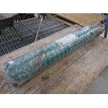 Roll of green safety barrier fencing