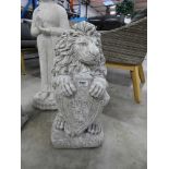 Concrete kneeling lion holding welcome plaque