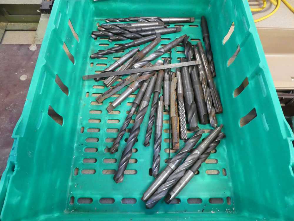 Crate containing a quantity of large heavy duty drill bits
