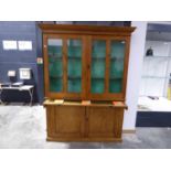 Stripped pine display cabinet with 2 glazed doors, 2 solid doors and tooled leather slide