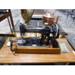 Manually operated Singer sewing machine serial EG676256 in hard case