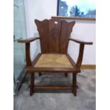 Rush seated oak armchair with emblem to back