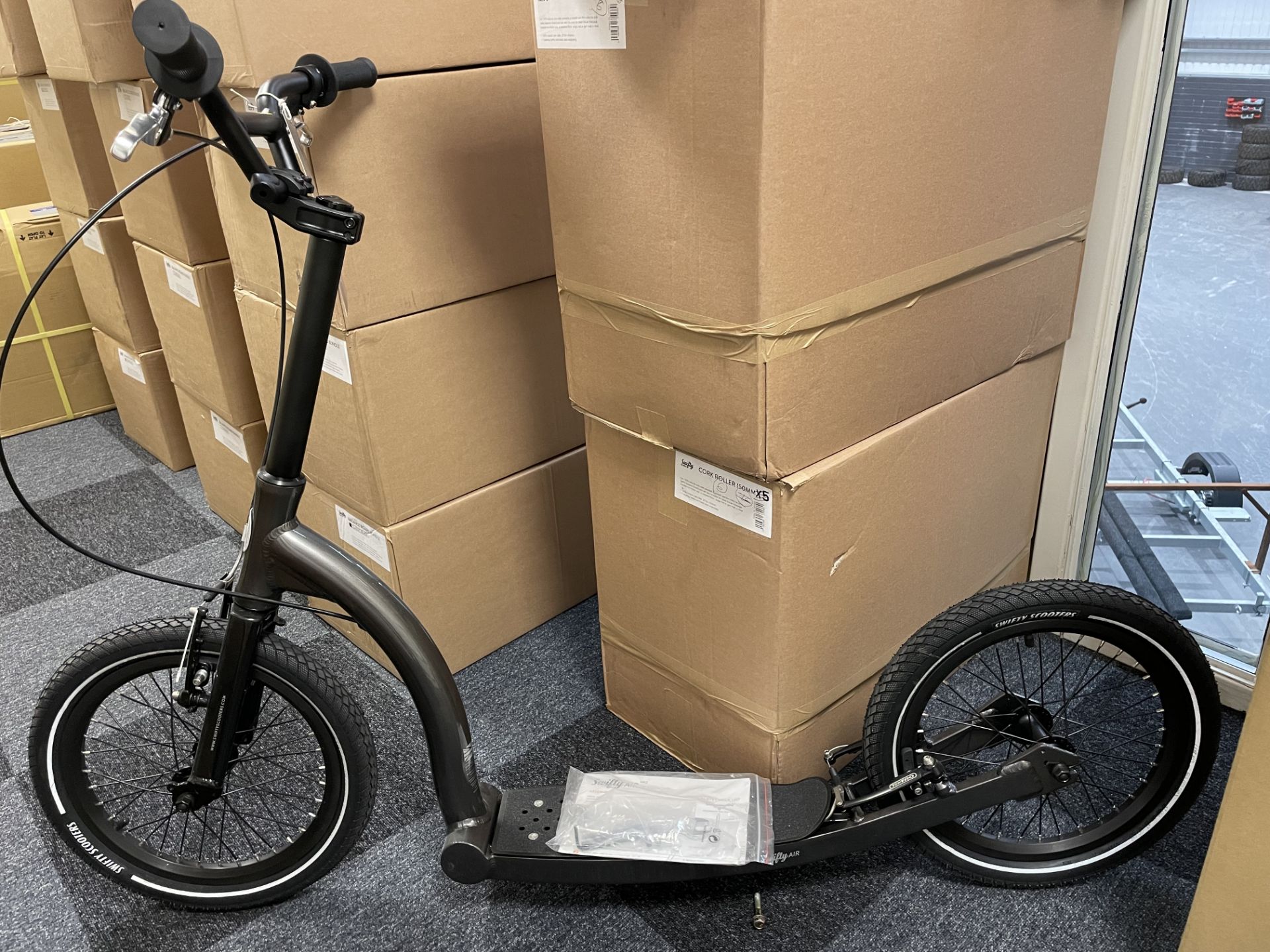 A Swifty Air Adult Kick Scooter, black anthracite with stand, RRP. £599 (as new, demonstrator).