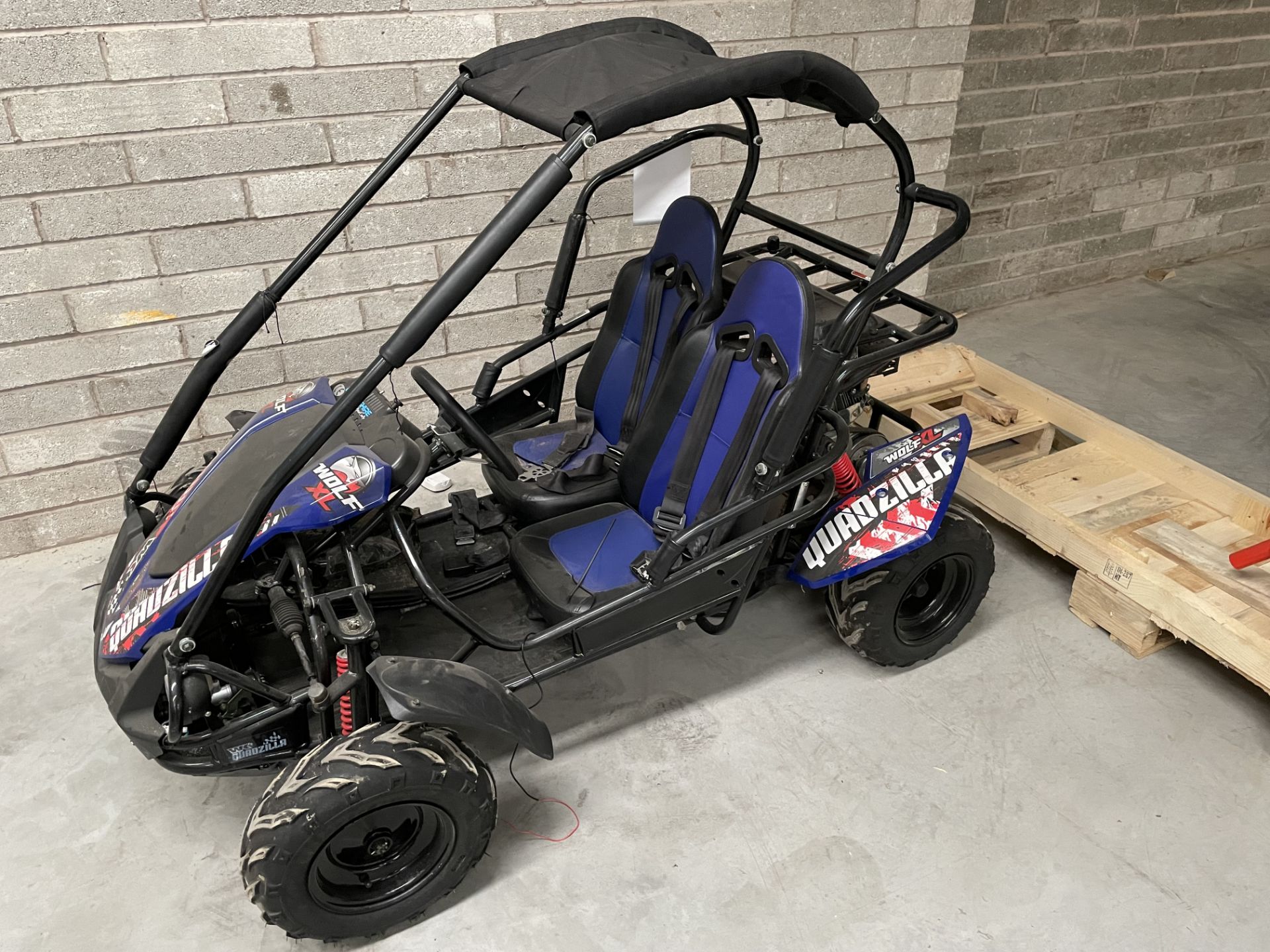 A Quadzilla Wolf XL Junior Off Road Buggy, 6.5HP engine, cloth canopy, no key.