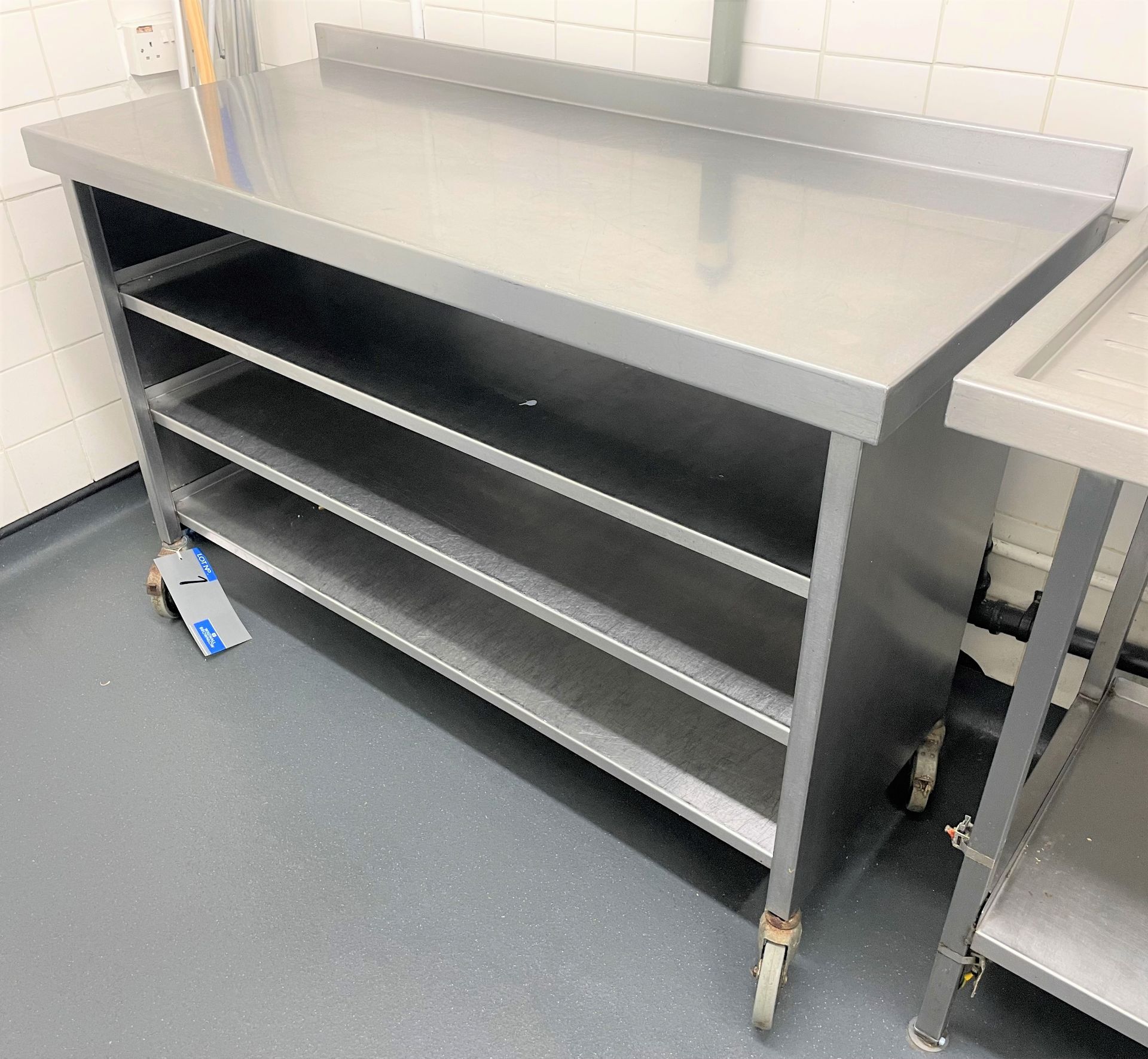 A Mobile Stainless Steel Bench with 3 undershelves, 1400mm x 600mm x 900mm h.