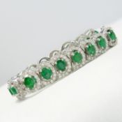 An exceptional 18ct white gold graduated 7.59 ct emerald and 2.67 ct diamond bracelet, boxed