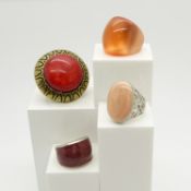 A collection of four large costume rings