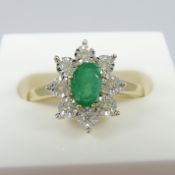 A 9ct yellow gold emerald and diamond cluster dress ring